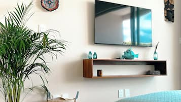 Exclusive Condo, Garden View | Living area | 50-inch Smart TV with digital channels