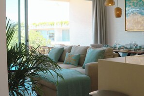 Exclusive Condo, Garden View | Living area | 50-inch Smart TV with digital channels