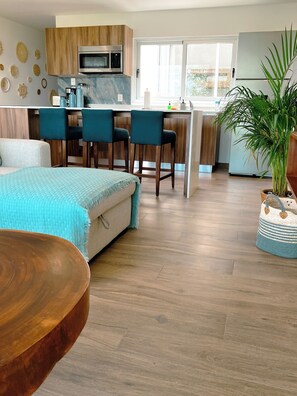 Exclusive Condo, Garden View | Living area | 50-inch Smart TV with digital channels