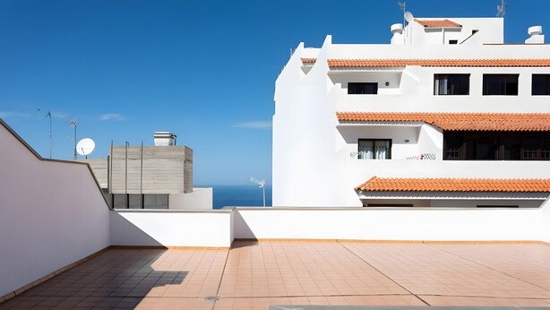 A rooftop terrace with a view of the sea, white buildings, and a satellite dish. - Holiday Apartment 'Rolycar 102' with Wi-Fi (Icod de los Vinos)