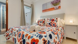 A bedroom with a bed, a nightstand, a painting, and a window. - Holiday Apartment 'Rolycar 102' with Wi-Fi (Icod de los Vinos)