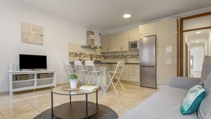 A modern living room with a grey sofa, a coffee table, and a flat-screen TV. - Holiday Apartment 'Rolycar 204' with Wi-Fi (Icod de los Vinos)