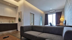 A modern living room with a sofa, a coffee table, and a kitchen area in the background. - Mykey Silverscape B-39-07 Melaka City (Melaka)