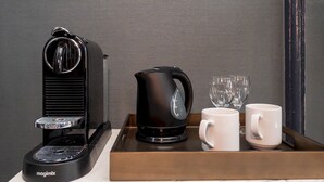 A Magimix coffee machine, a black electric kettle, and two white mugs on a tray.