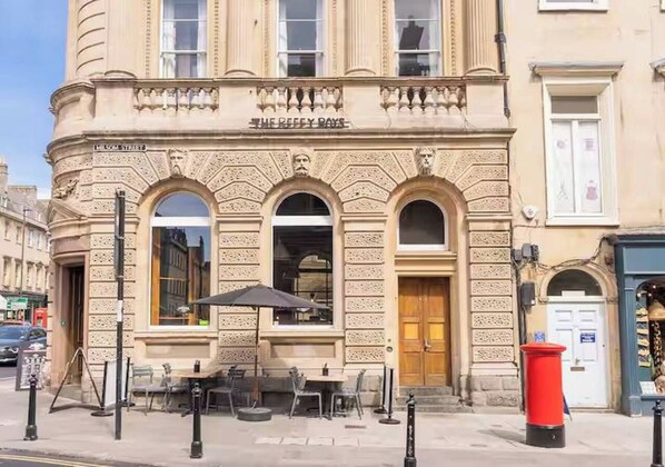 A building with a sign 'The Reefy Rose' and a street name 'Milsom Street'.