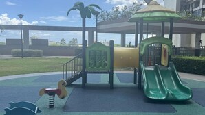 A playground with a slide, climbing structures, and a spring-mounted toy. - Levi & Moon Relax and Chill (Pasay City)