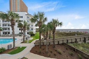 A hotel with a pool, palm trees, and a beach view. - Palm Beach D-21  Great Views (Orange Beach)