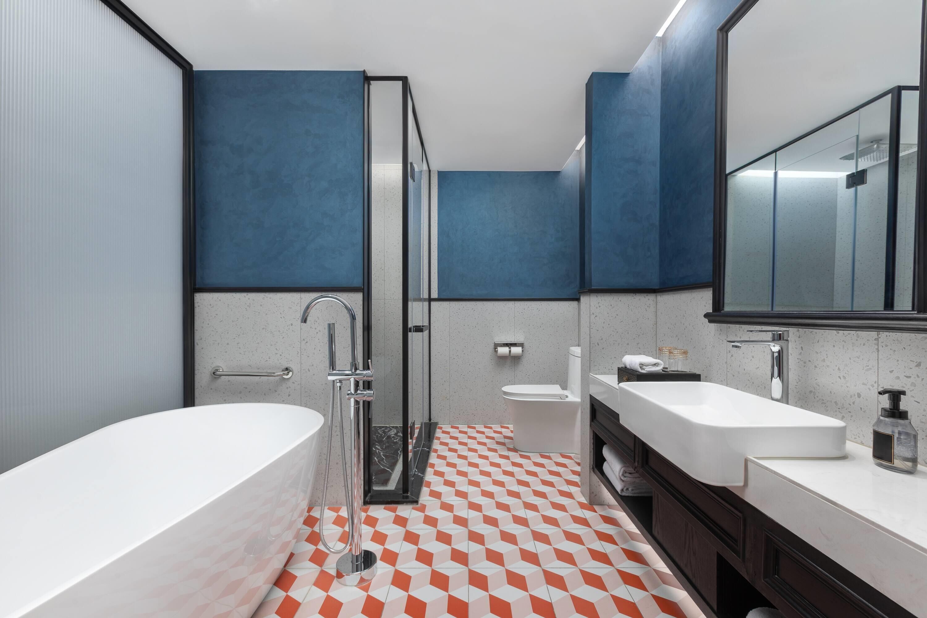 A modern bathroom with a bathtub, a shower, and a sink.