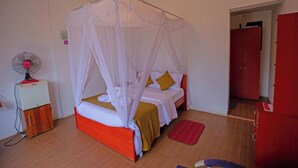 A room with a bed under a canopy, a fan, and a red wardrobe. - Ella Floating View (Ella)