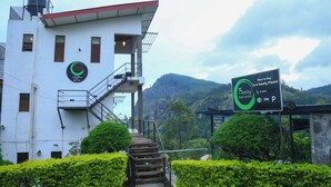 A white building with a sign advertising a restaurant and reception. - Ella Floating View (Ella)