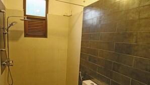 A small bathroom with a shower, toilet, and sink. - Ella Floating View (Ella)