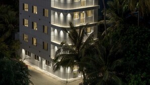 A multi-story hotel with balconies, a rooftop terrace, and a view of the ocean. - Nest by Hawks Hotels Kamadhoo Baa Atoll (Kamadhoo)