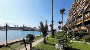 A hotel with a pool, palm trees, and a clear view of the water. - Nonstop electricity 1 bedroom beachfront apartment & Seaview Family Duplex (Jabal Lubnan)