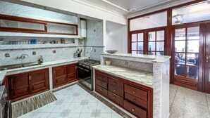 A kitchen with wooden cabinets, a stove, and a marble countertop. - Stunning 3-bedroom apartment  with panoramic ocean views, located in the heart of Tangier´s playa (Tangier)