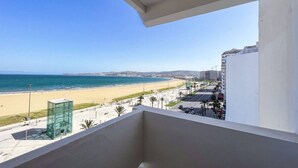 A balcony with a view of a beach and ocean. - Stunning 3-bedroom apartment  with panoramic ocean views, located in the heart of Tangier´s playa (Tangier)