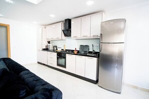 Fridge, microwave, oven, stovetop - The perfect coastal getaway, just steps from the beach, with a private balcony, open living area. (Tangier)