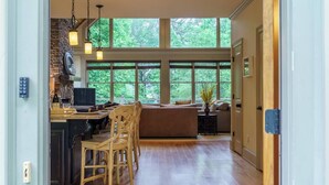 A spacious kitchen with a dining area, large windows, and a cozy seating area. - Beautiful Lake Home/Private Dock (Gainesville)