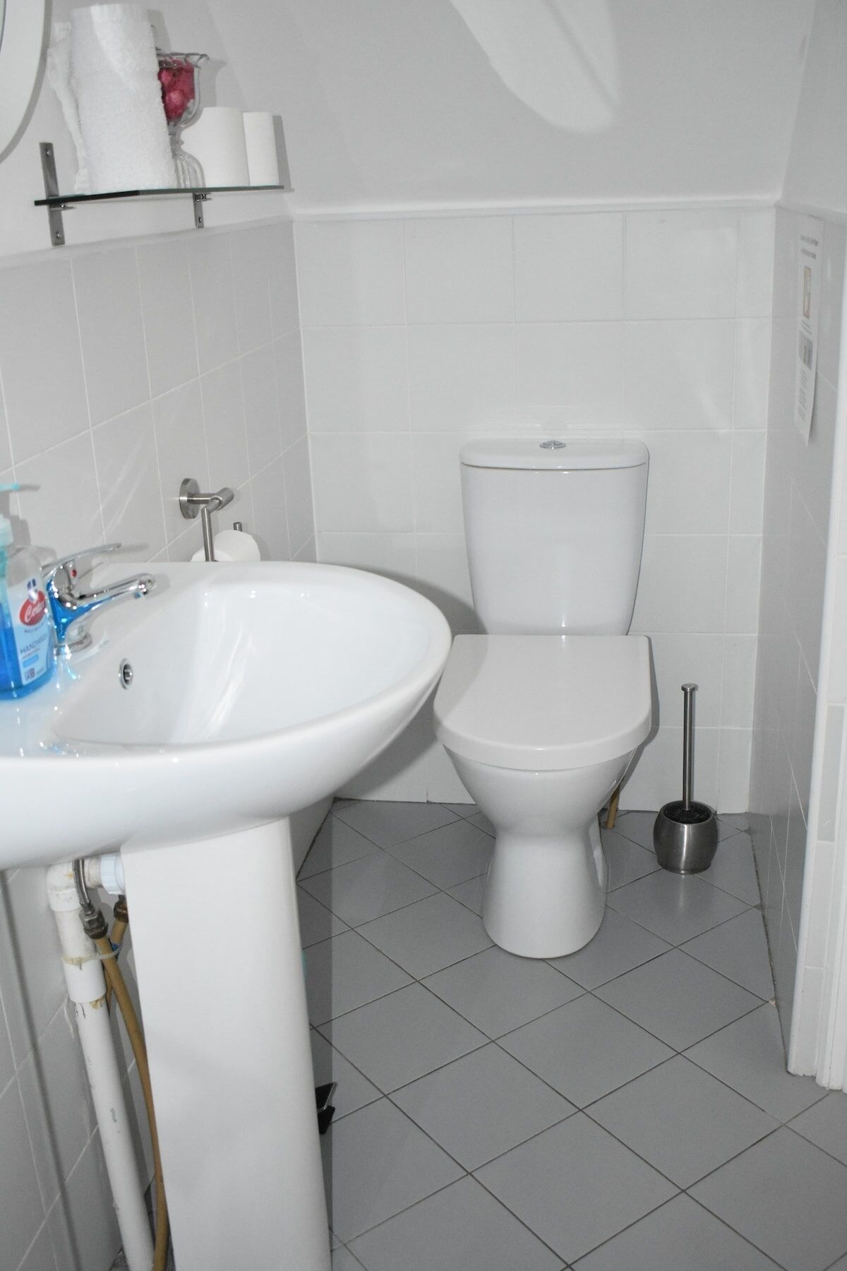 A bathroom with a white sink, toilet, and bidet.