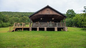 A wooden cabin with a balcony, stone pillars, and a staircase leading up to it. - Secluded cabin on 20acres boarding the George Washington National Park (Mathias)
