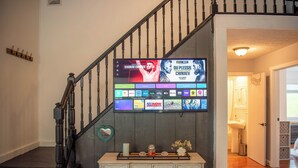 A staircase with a flat-screen TV displaying UFC content. - Secluded cabin on 20acres boarding the George Washington National Park (Mathias)