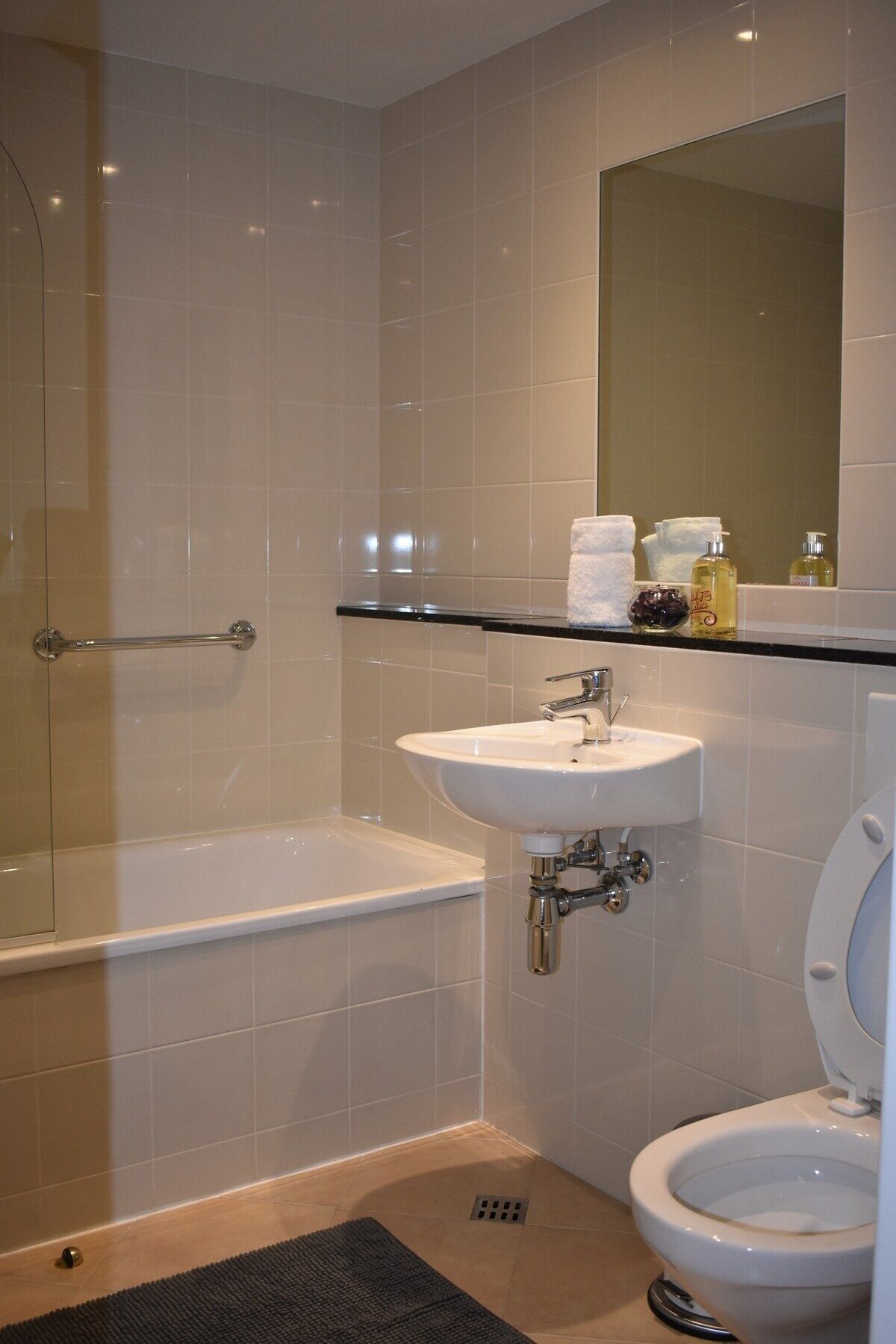 A bathroom with a bathtub, a sink, and a toilet.