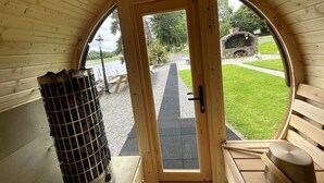 A cozy wooden interior with a large arched doorway leading outside.