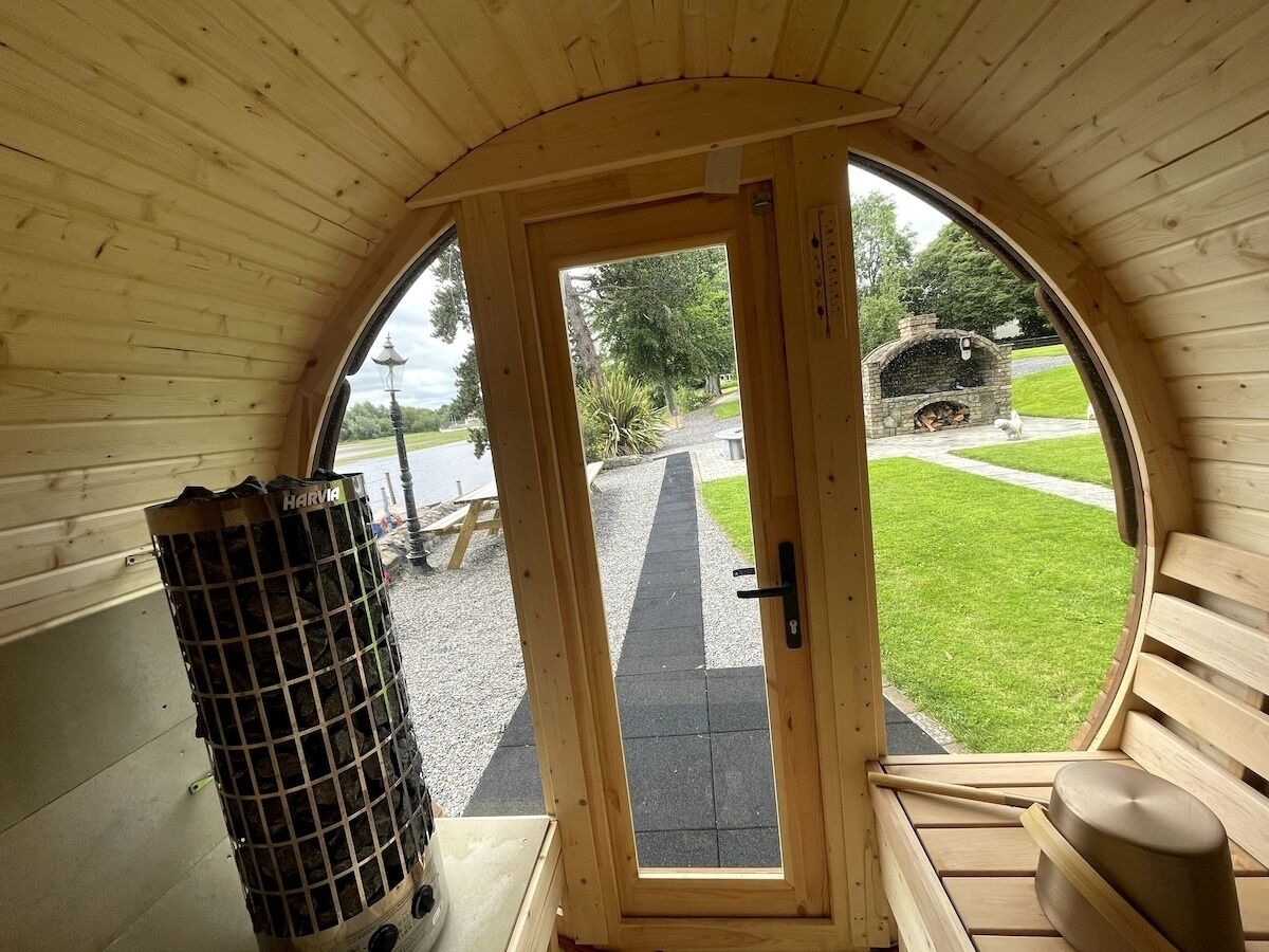 Um interior de madeira acolhedor com uma grande porta em arco que dá para o exterior.