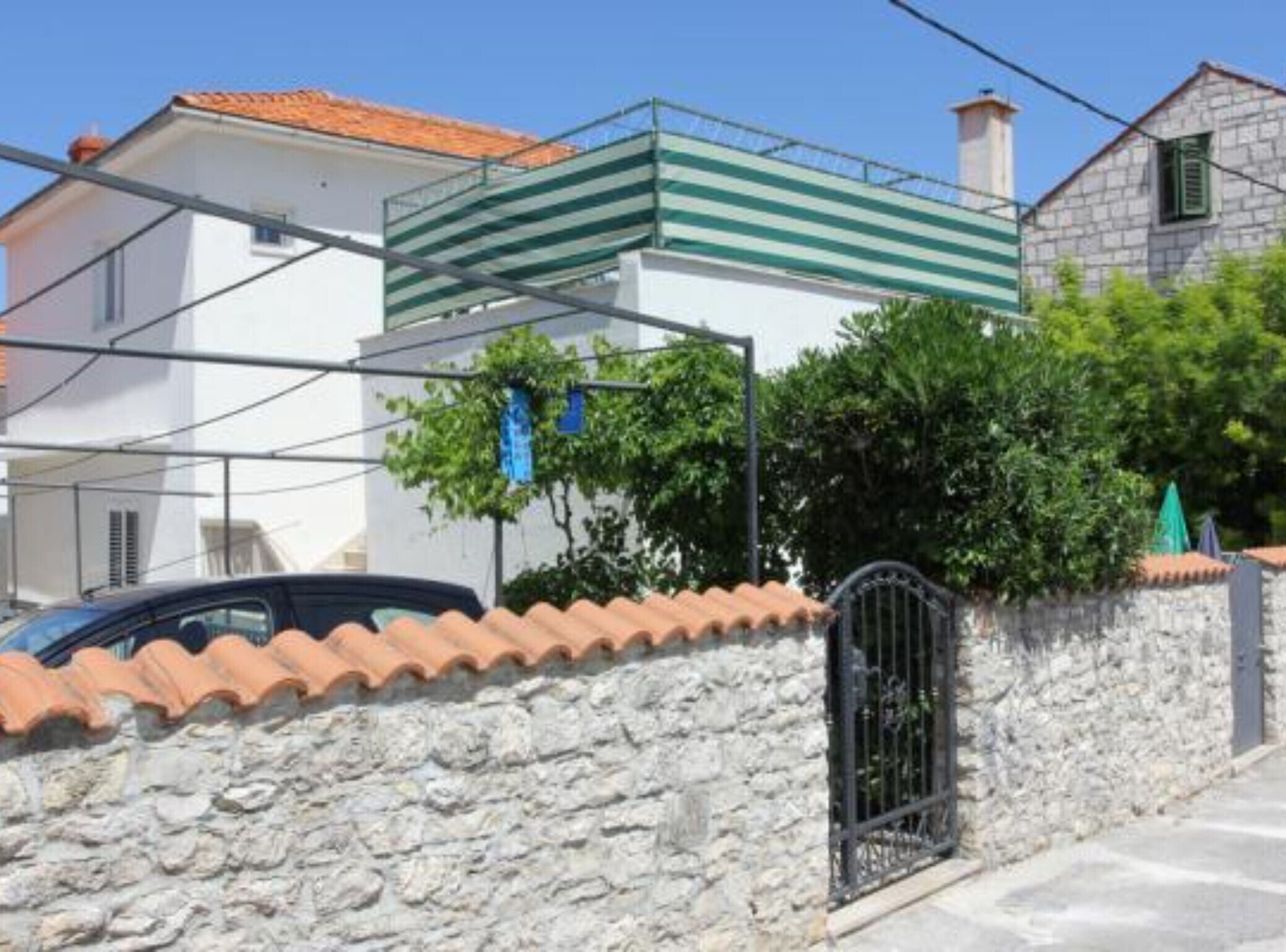 A two-story building with a stone facade and a tiled roof.
