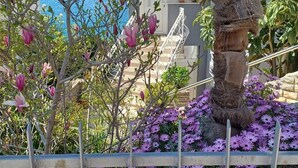 A view of a balcony with a railing, a staircase, and a body of water in the background. - Apartments Bilić Trogir - Three- Bedroom Apartment With Sea View (A3) (Trogir)