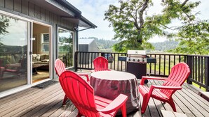 A wooden deck with a barbecue grill, red chairs, and a table. - 2 Mi to Downtown Coos Bay: Home w/ Deck, Fire Pits (Coos Bay)