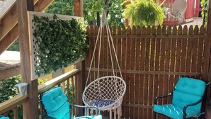 A wooden pergola with hanging lights, a hanging chair, and two turquoise chairs with cushions. - Cozy, spacious 1 bdrm apt in Bloomfield with off street parking. Great location! (Pittsburgh)