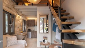 A modern interior with a staircase, a kitchen, and a living area.