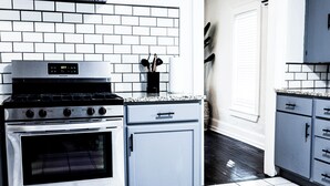 A kitchen with a stainless steel stove, a built-in oven, and a grey cabinet. - Quaint 3BR - Minutes to Downtown San Angelo - Sleeps 6 (San Angelo)