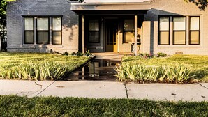 A two-story building with a flat roof, large windows, and a small front porch. - Quaint 3BR - Minutes to Downtown San Angelo - Sleeps 6 (San Angelo)