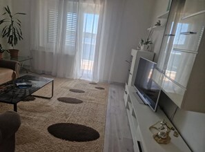 Apartment (Three-Bedroom Apartment With Sea View) | Living room | 32-inch flat-screen TV with satellite channels