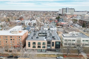 A multi-story building with a flat roof, large windows, and a central courtyard.
