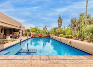 A swimming pool with a sun lounger and a patio area with plants and a cactus. - Charming 3-bedrm furnish house in Scottsdale with AC and casita.  30 day rental (Scottsdale)
