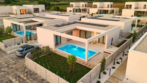 A modern residential complex with multiple detached houses, each featuring a rooftop pool and solar panels. - Gorgeous home in Tar with private swimming pool, can be inside or outside (Tar)