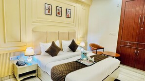 A hotel room with a bed, bedside table, lamp, and a wardrobe.