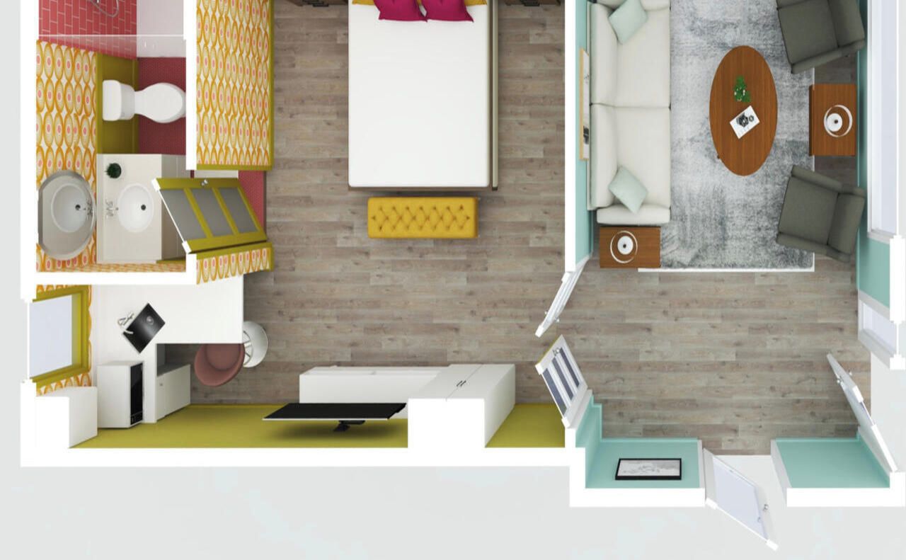 Une chambre d’hôtel moderne équipée d’un lit, d’un canapé, d’une petite table, d’un bureau et d’une salle de bain avec des toilettes et un lavabo.