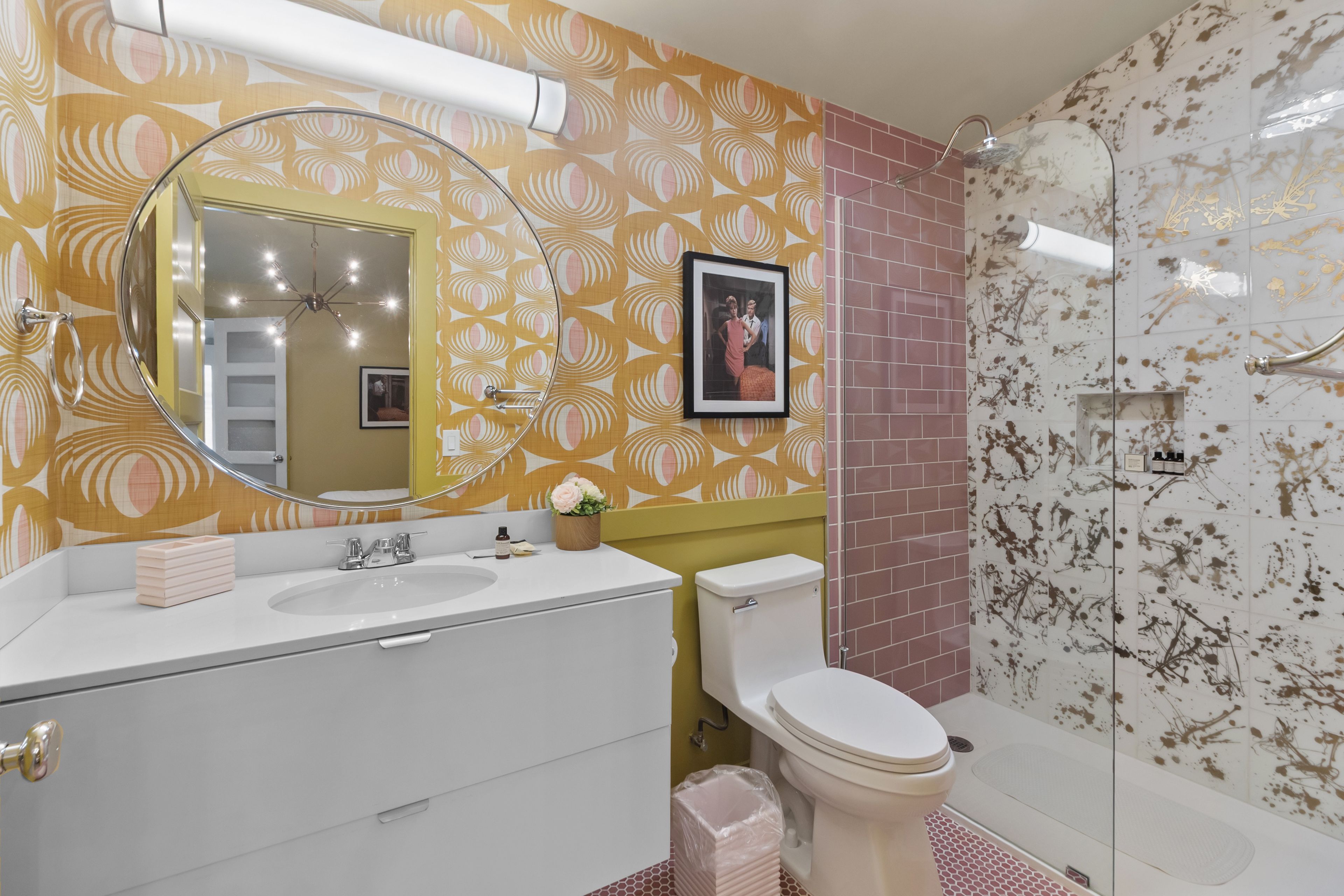 A bathroom with a white sink, a toilet, and a shower area.