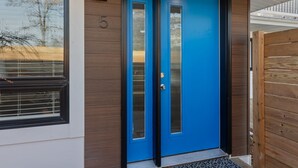 A blue door with a number '5' on the wall beside it.