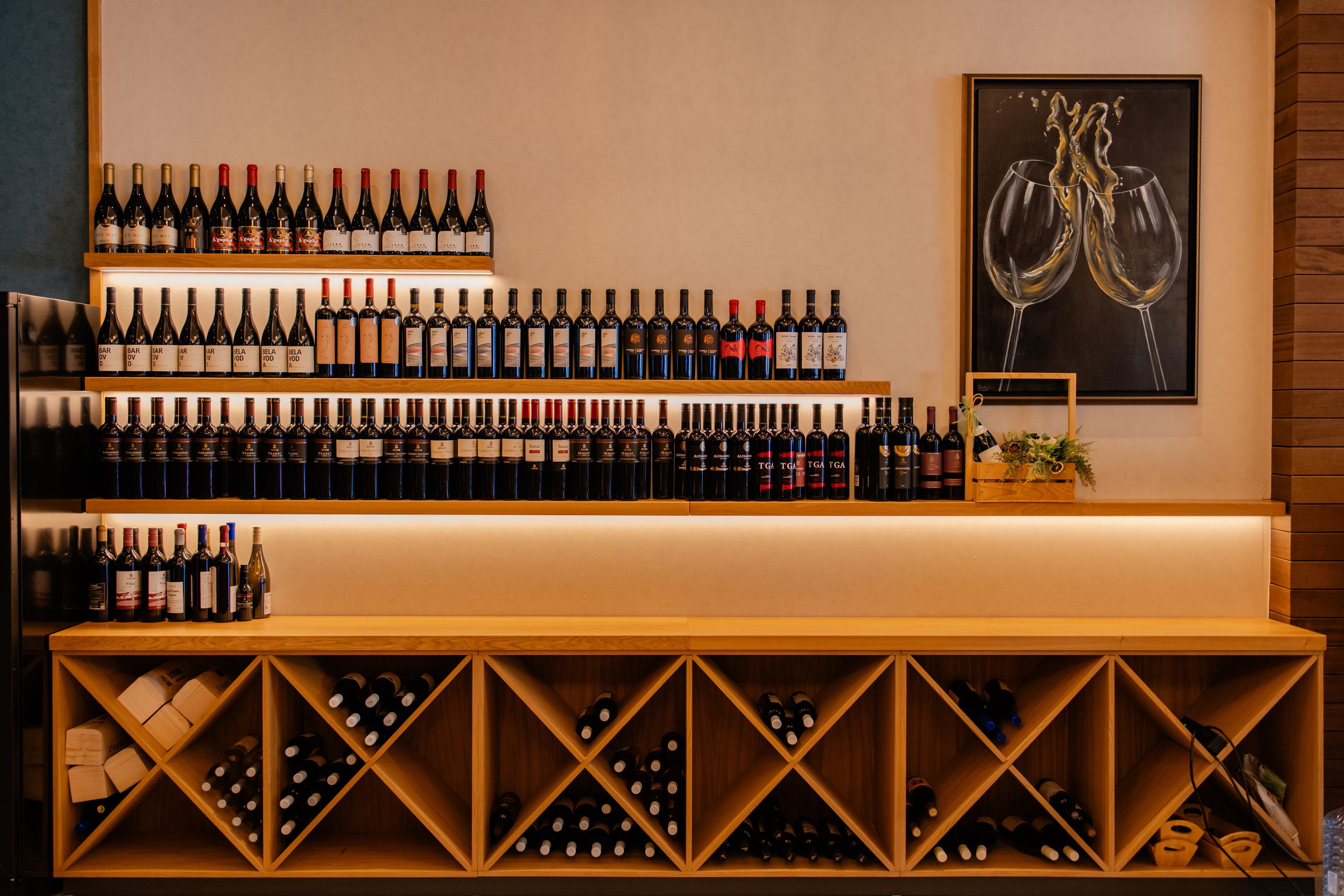 A wine cellar with multiple shelves and wooden racks filled with wine bottles.