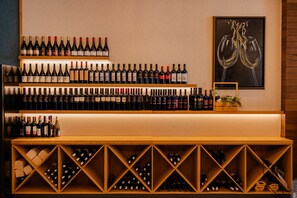 A wine cellar with multiple shelves and wooden racks filled with wine bottles. - Lago Hotel & Spa (Ohrid)