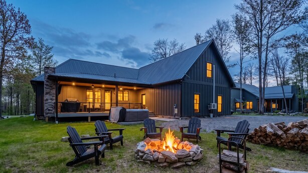 A large house with a deck, outdoor seating, and a fire pit. - Holiday House by Taylor Made Deep Creek (McHenry)