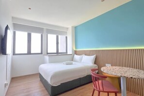 A bedroom with a bed, a table, and a chair. - Riveria City Kuala Lumpur Sentral by Archos (Kuala Lumpur)