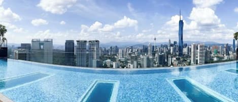 A swimming pool with a city skyline view.