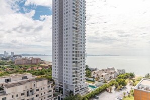 A high-rise building with a view of the sea and other buildings in the background. - Residence by Hello Pattaya at Veranda (Sattahip)