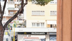 A McDonald's restaurant with a holding sign, a traffic light, and a tree in the foreground. - Spacious BnB with 3 rooms and kitchen, a few steps from St. Peter's (Roma)