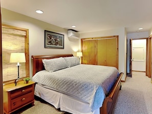 A bedroom with a bed, bedside tables, a wardrobe, and a picture on the wall. - Somewhere by Taylor Made Deep Creek (Oakland)